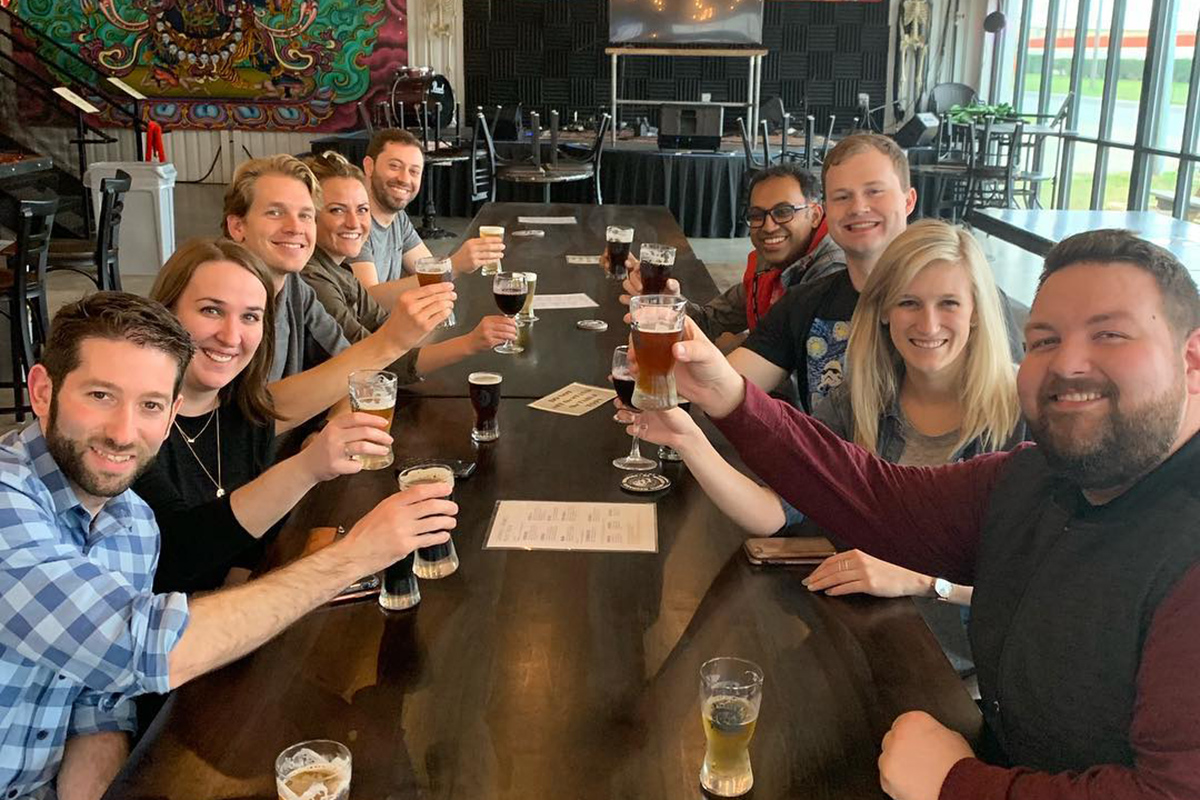 Austin Brewery Tours group toasting at Skill Mechanix Brewing tasting room.