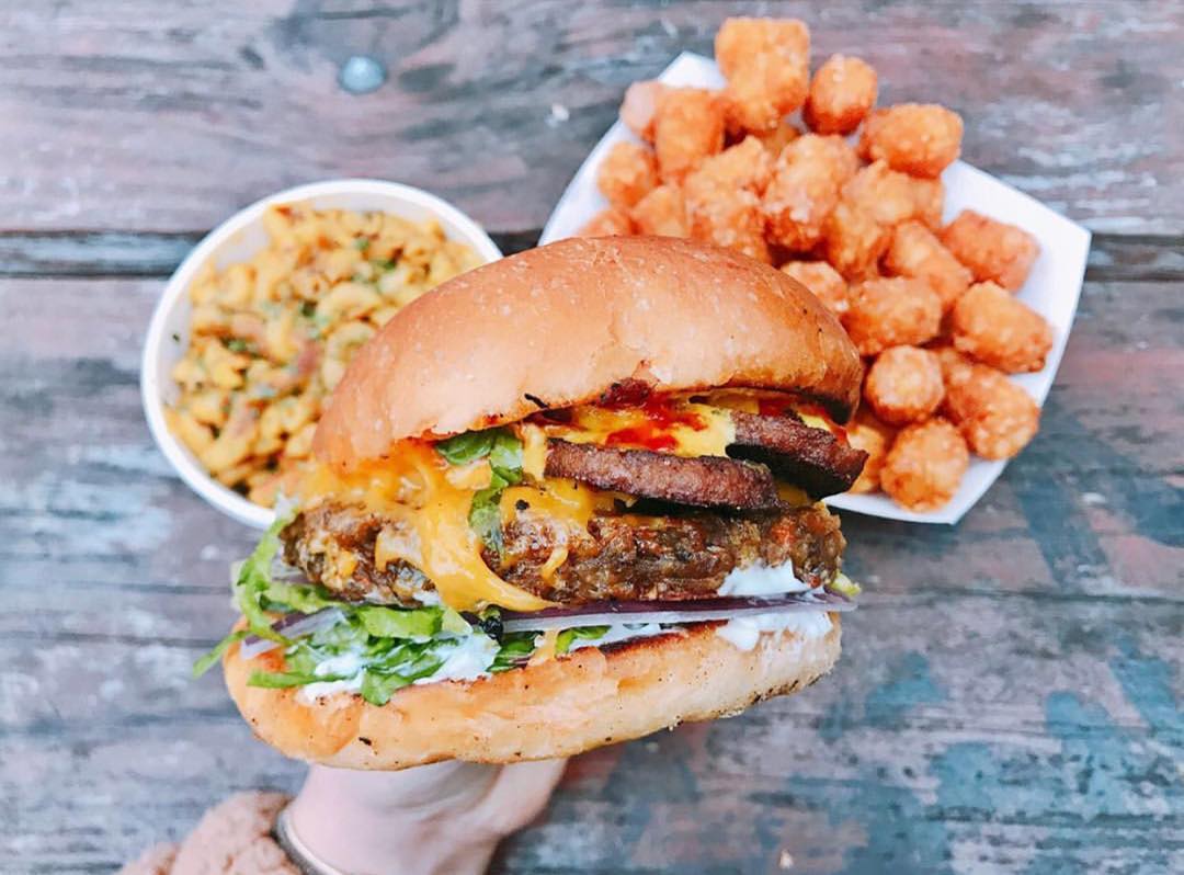 Burger in the hand at Arlo's Austin.